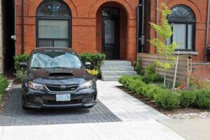 Concrete barriers blocking a Toronto front yard parking pad in a residential neighbourhood
