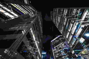 Luxury condominium towers in downtown Toronto illuminated at night with many dark windows visible across the skyline