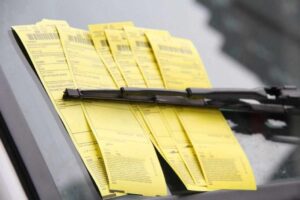 Multiple Toronto parking tickets attached to a vehicle windshield.