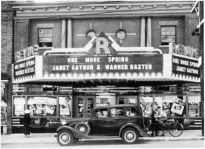 Historic 1935 photo of the Revue Theatre on Roncesvalles Avenue in Toronto, showing the old marquee, people outside the entrance, and a vintage car at the curb.