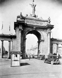 Historic Princes Gates entrance at Exhibition Place in Toronto built in 1927 for the Canadian National Exhibition, showing early automobiles passing through the arch